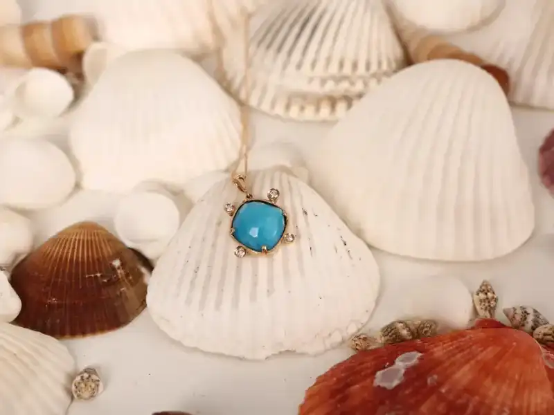 White and orange seashells with a turquoise pendant